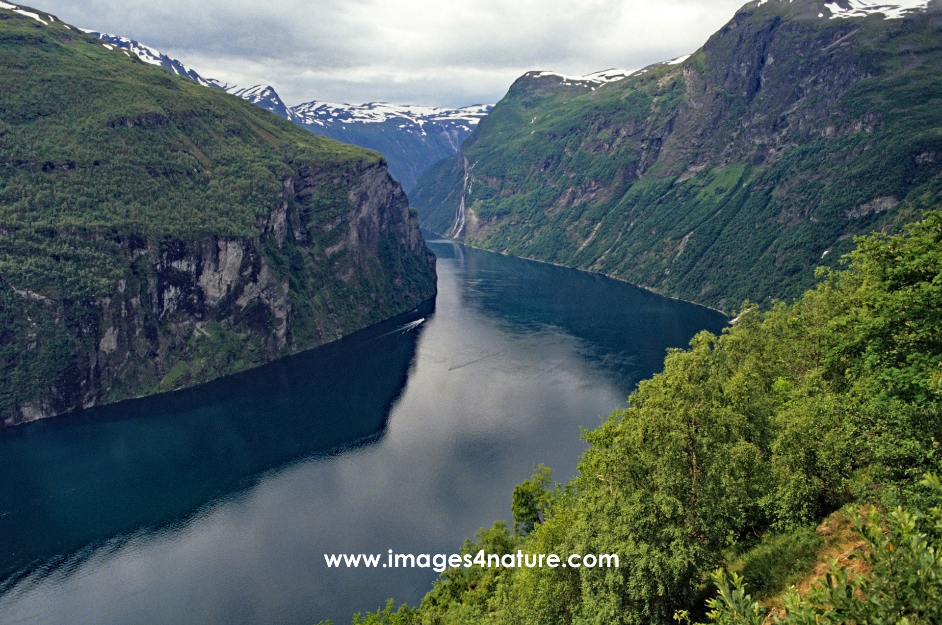 Scenic view of the majestic steep rock faces at Geiranger fjord