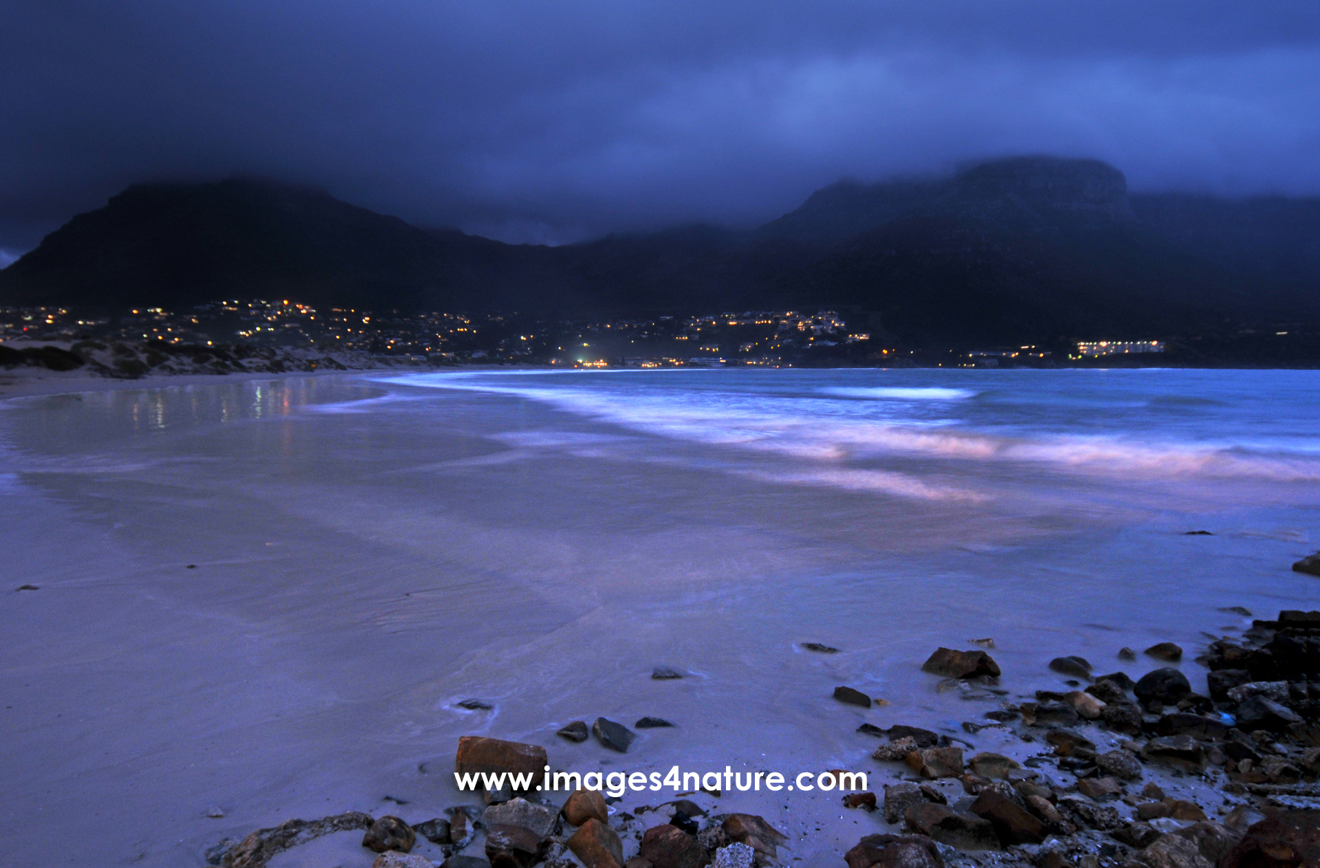 Evening view of Hout Bay with waves rolling onto empty beach