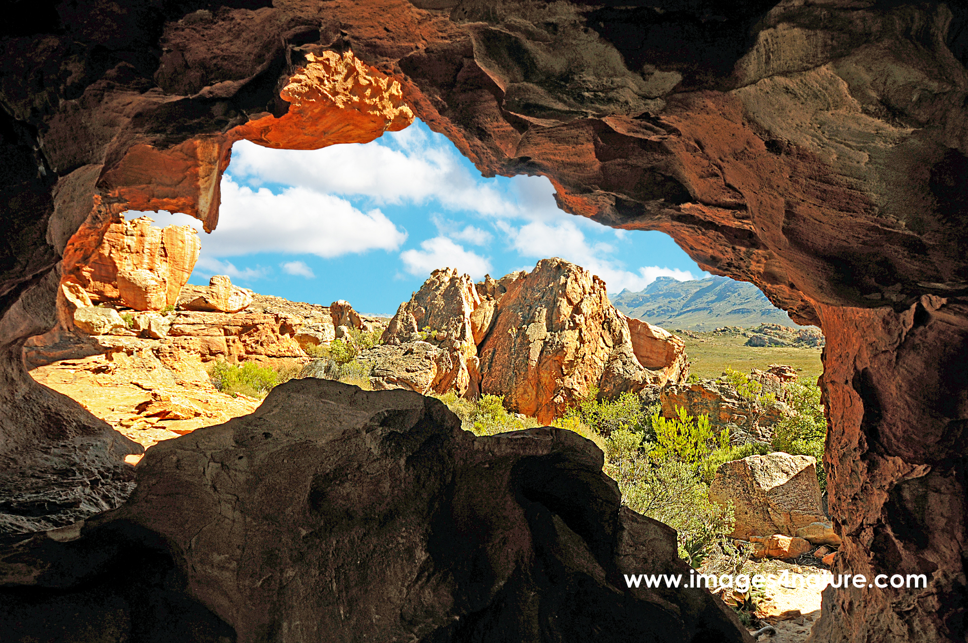 View from a sandstone cave on a beautiful landscape against sky