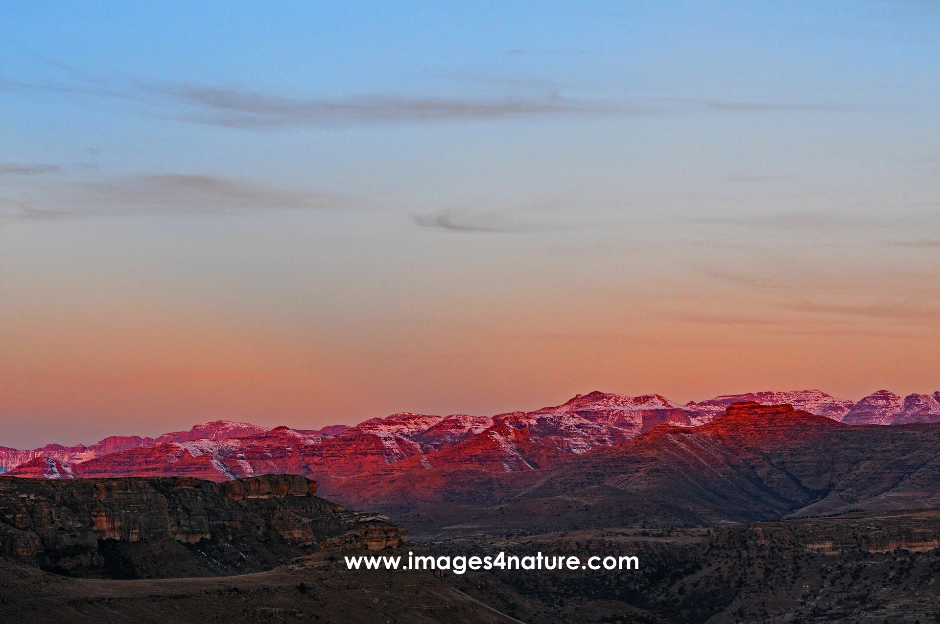 Mountain range of Golden Gate highlands glowing red at sunset