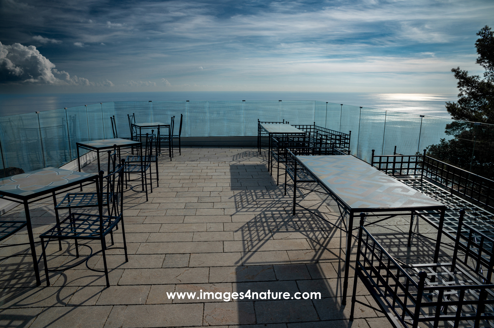 Scenic view from lounge deck with chairs and tables over the sea