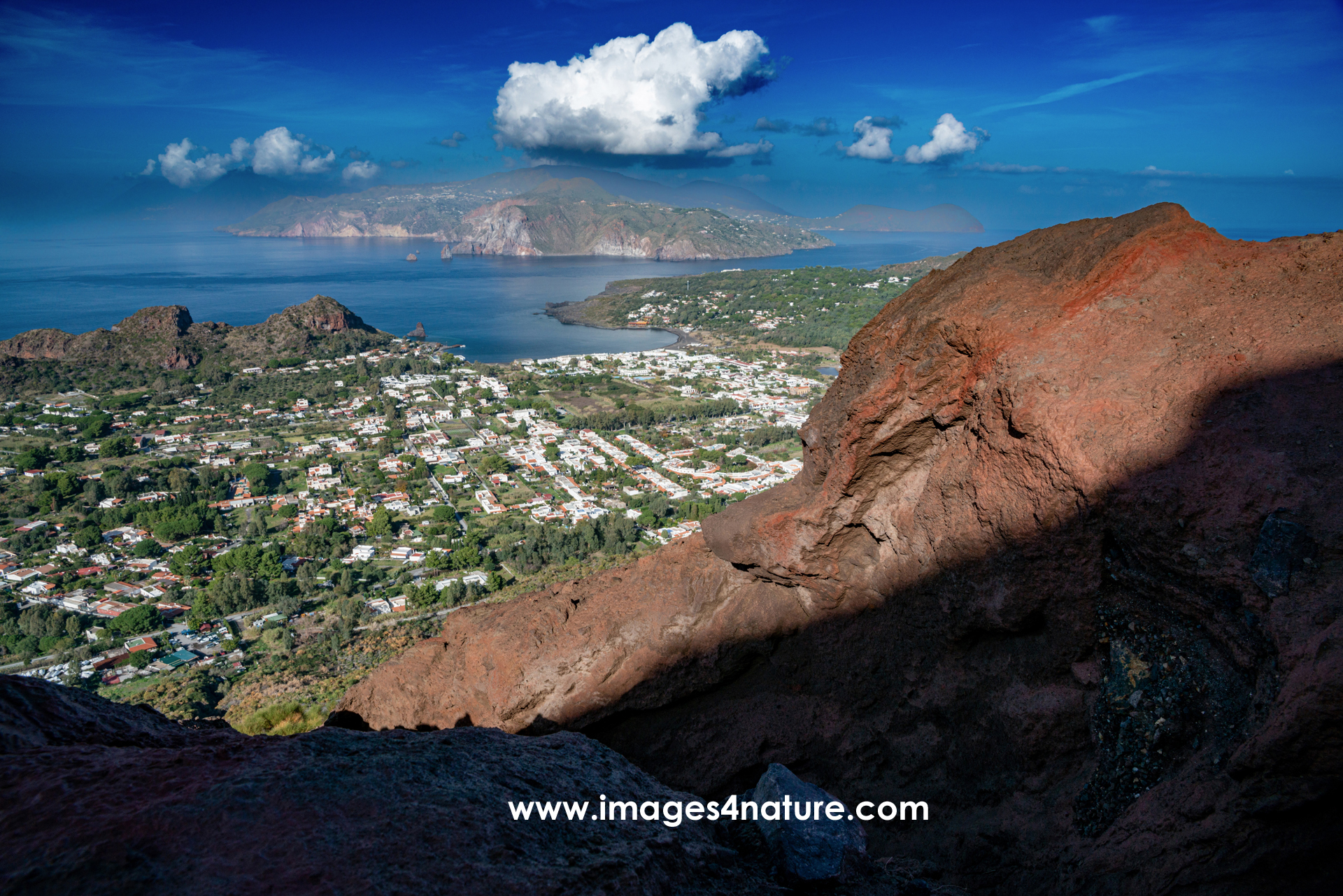 Scenic view Volcano village and Lipari against blue sky and clouds