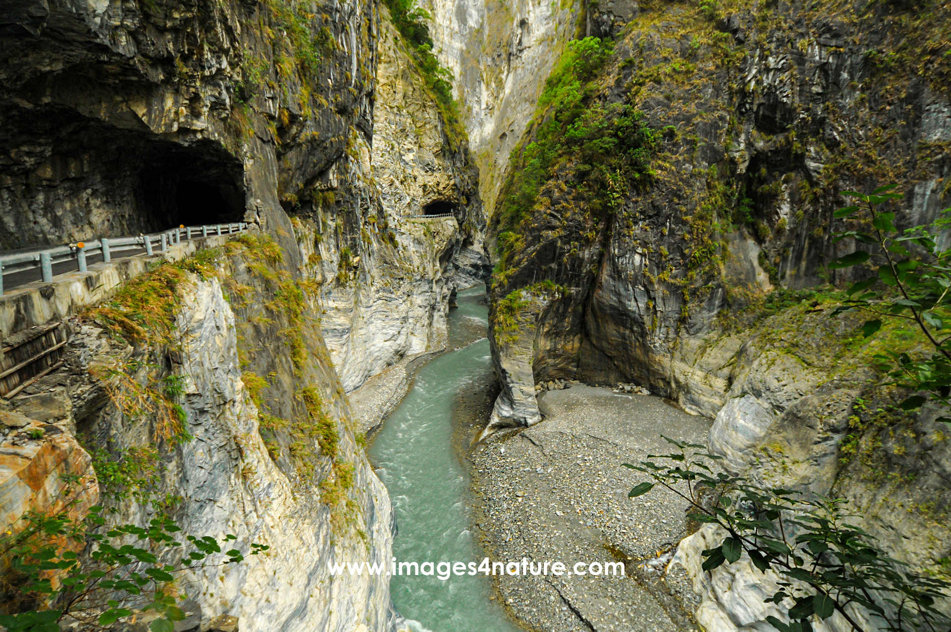 Narrow road with tunnels and clear stream in steep Taroko Gorge