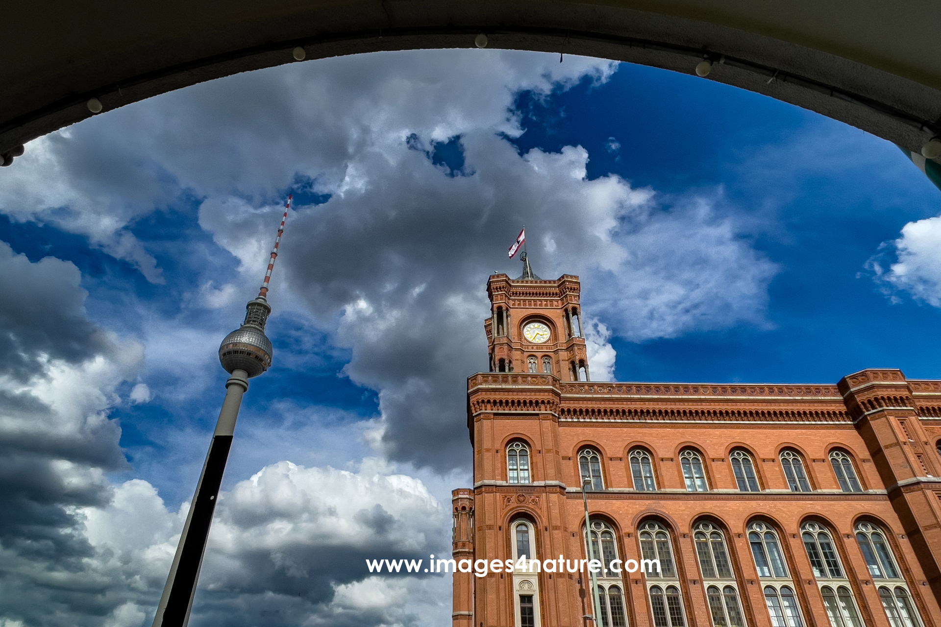 Low angle view of Berlin TV Tower and Red Town Hall against sky