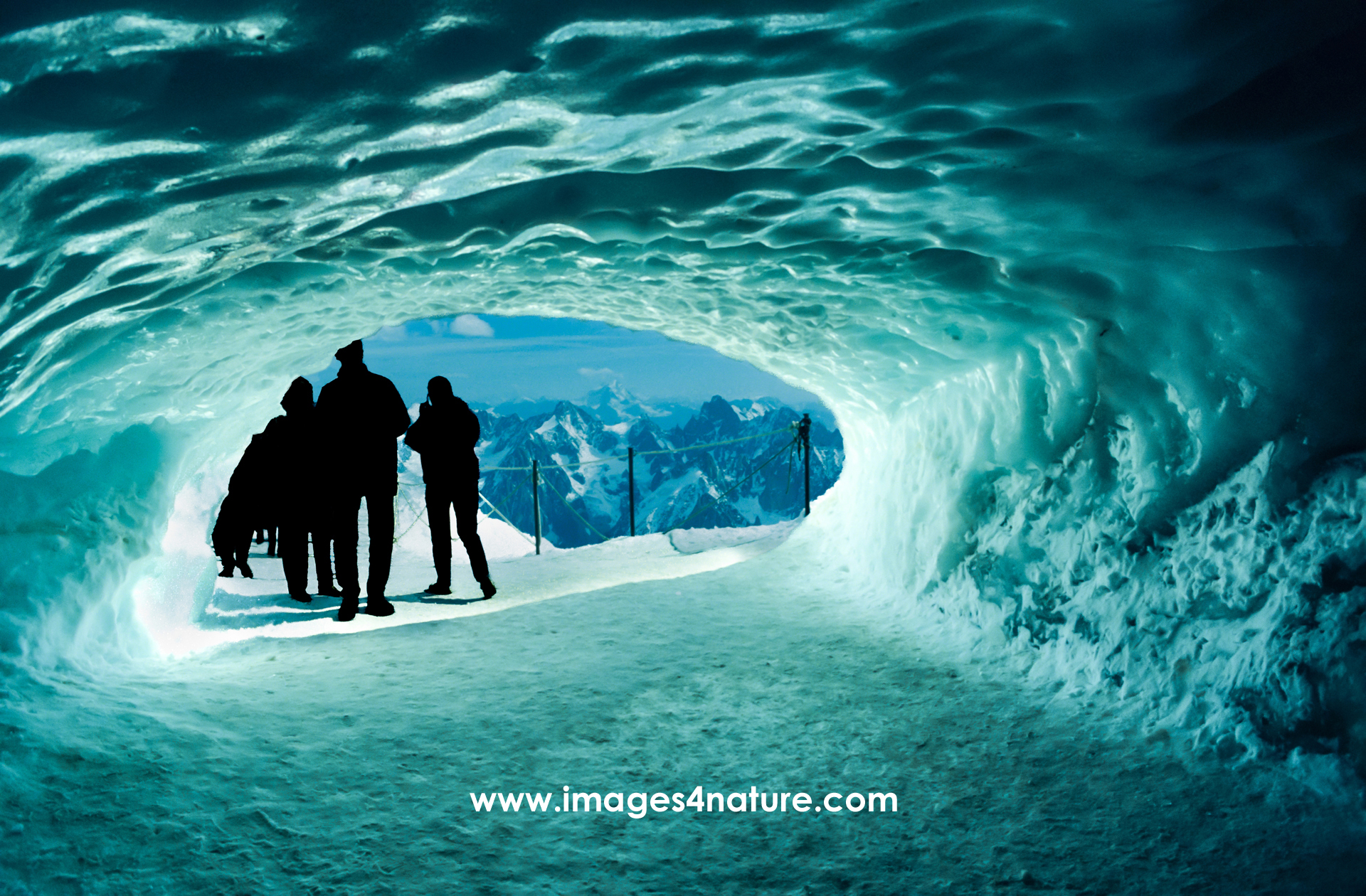 Silhouette of people at the end of a tunnel made of ice