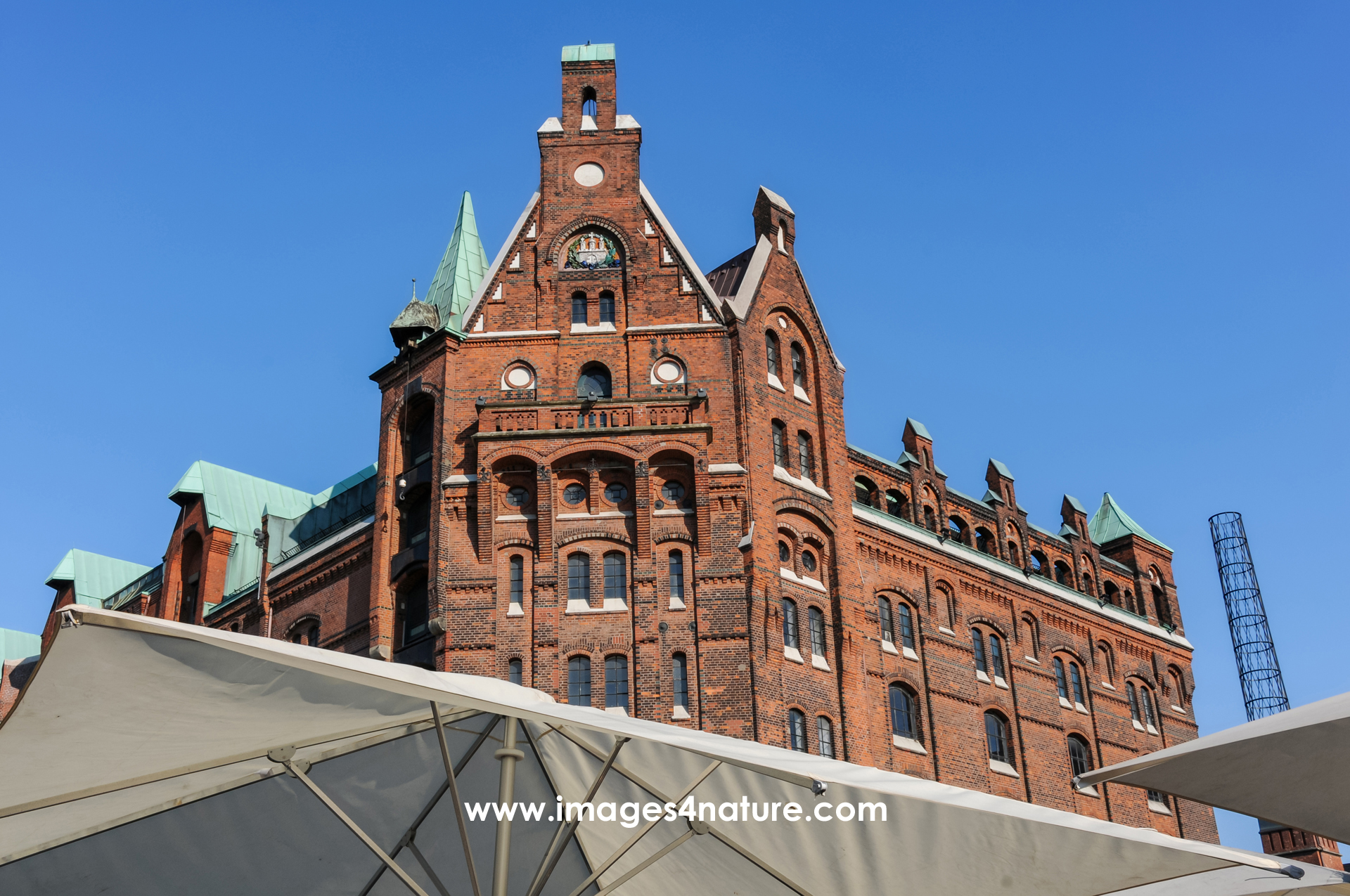 Hamburg Speicherstadt harbour city hall and sunshades against blue sky