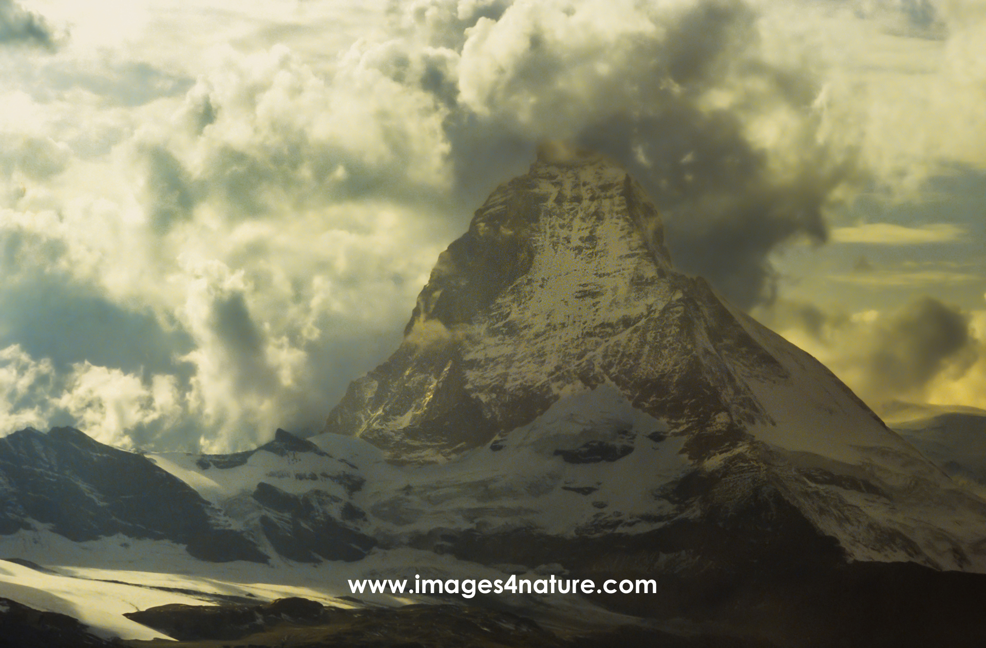 Scenic view of Matterhorn surrounded by sun illuminated clouds