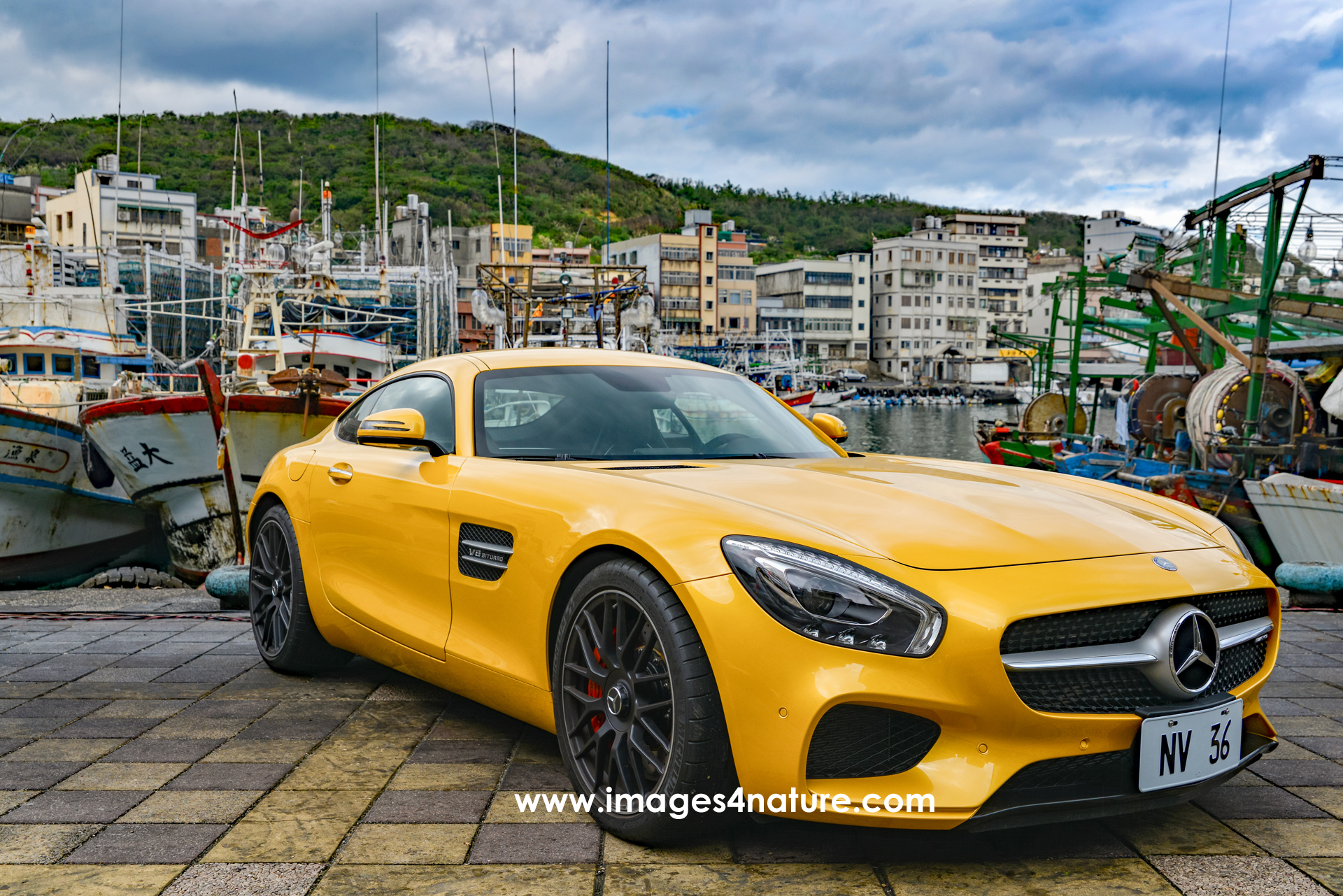 Mercedes AMG GT Coupe parked at traditional fishing harbour