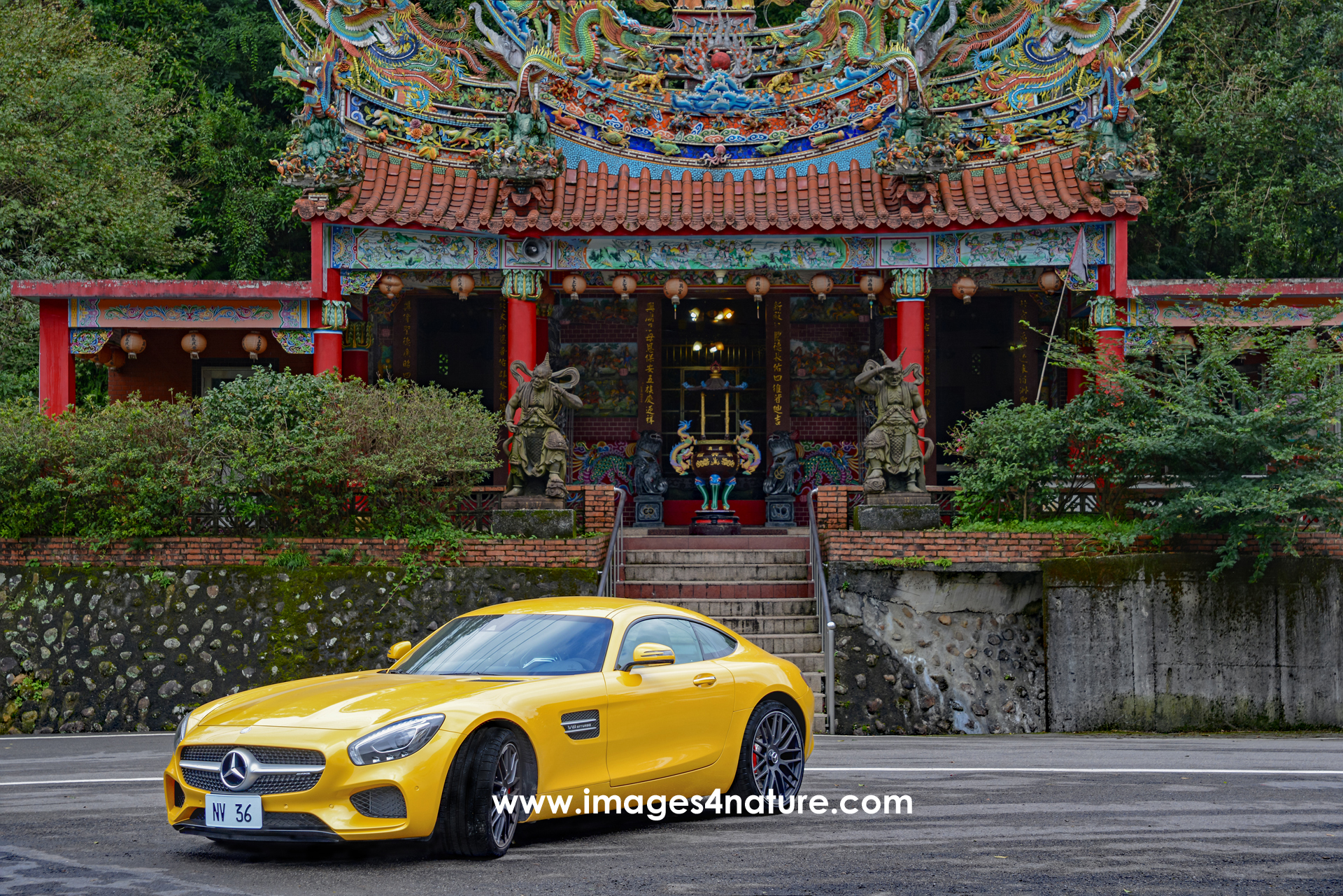 Yellow Mercedes AMG GT parked in front of Buddhist temple