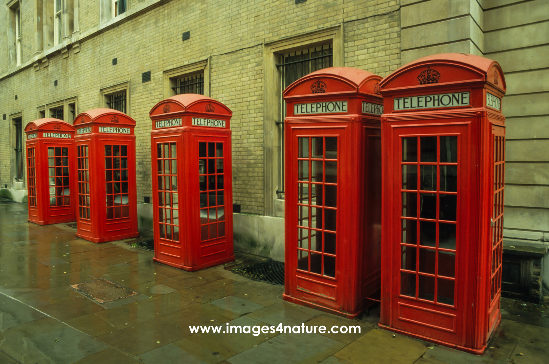 Diagonal group of five red English telephone booths