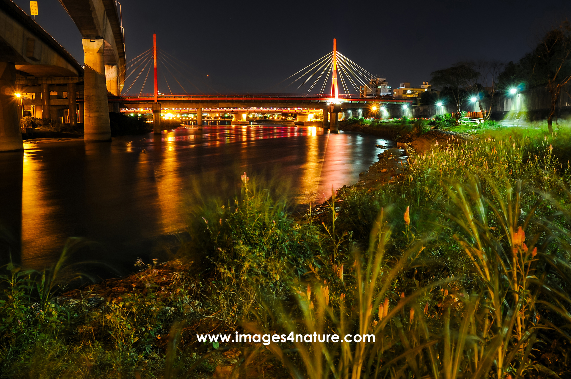 Scenic view of Keelung River with bridges at night