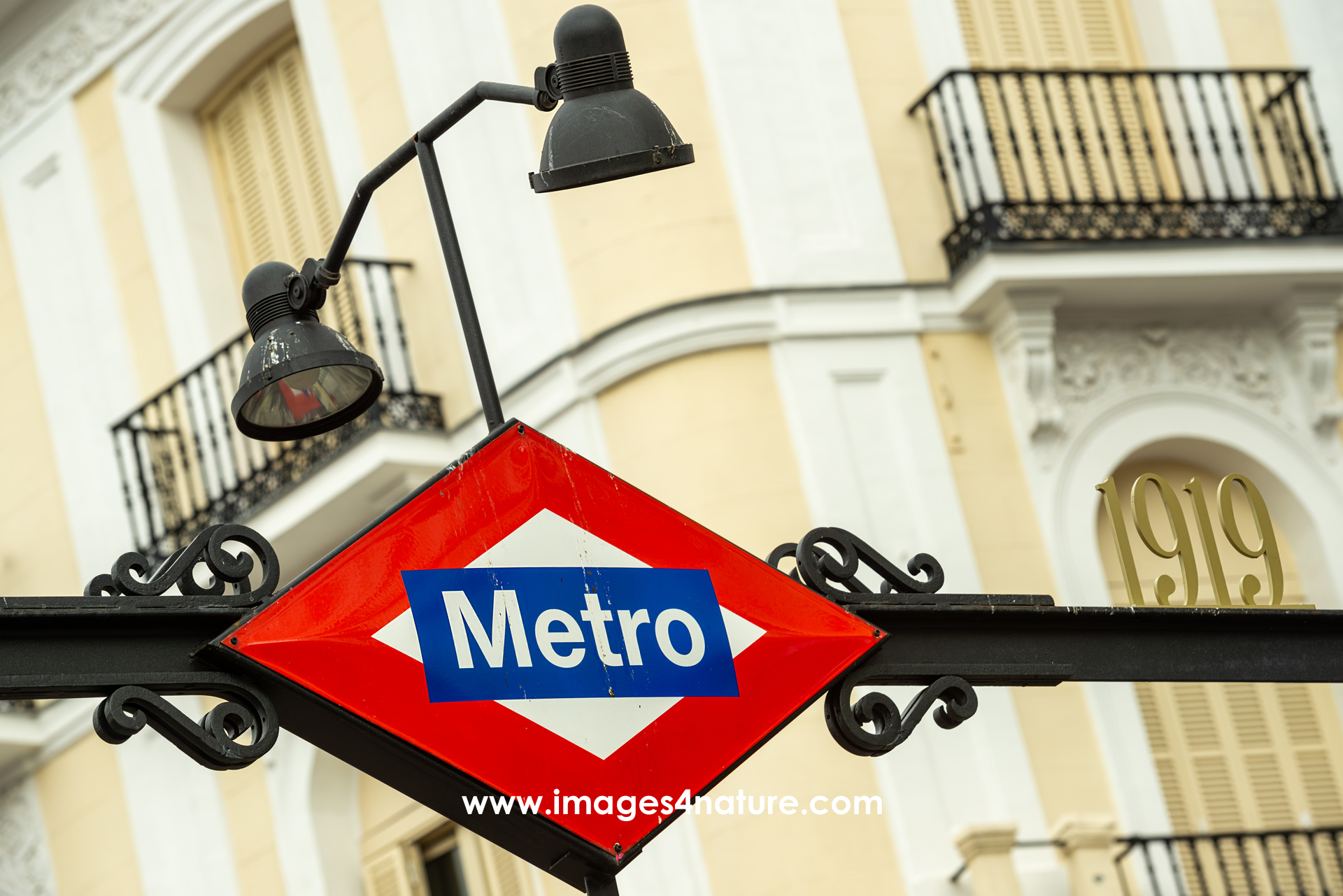 Metro station sign with nice Madrid building facade as background