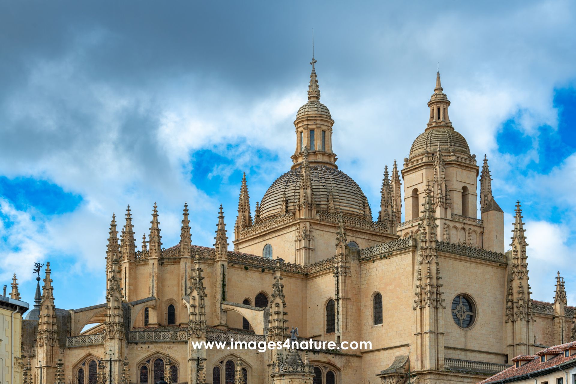 Scenic view of the Gothic cathedral of Segovia against cloudy blue sky