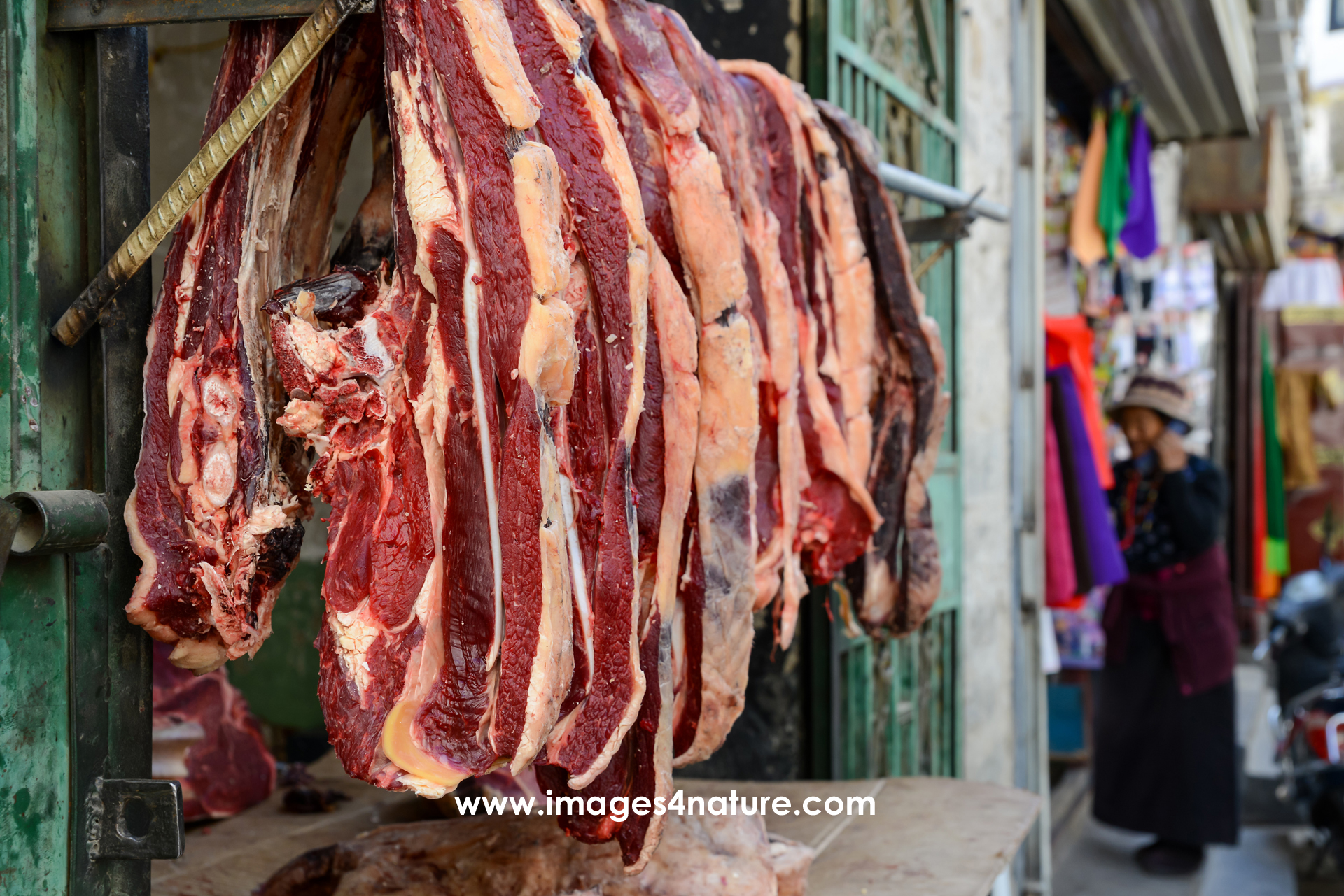Pieces of fresh meat hanging outside a butchery in Lhasa Old Town