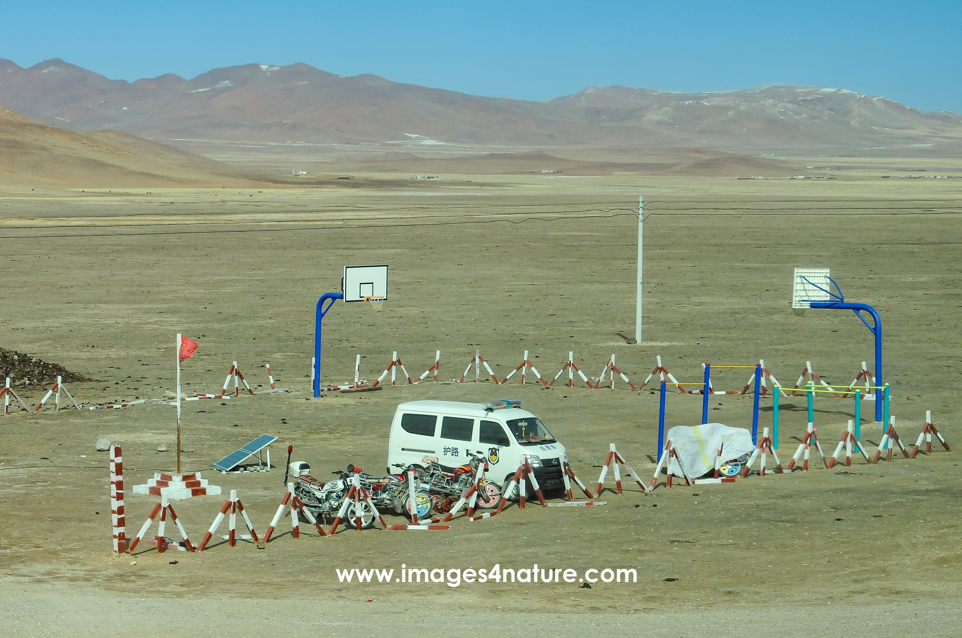 Basketball court in a remote Tibetan highlands landscape
