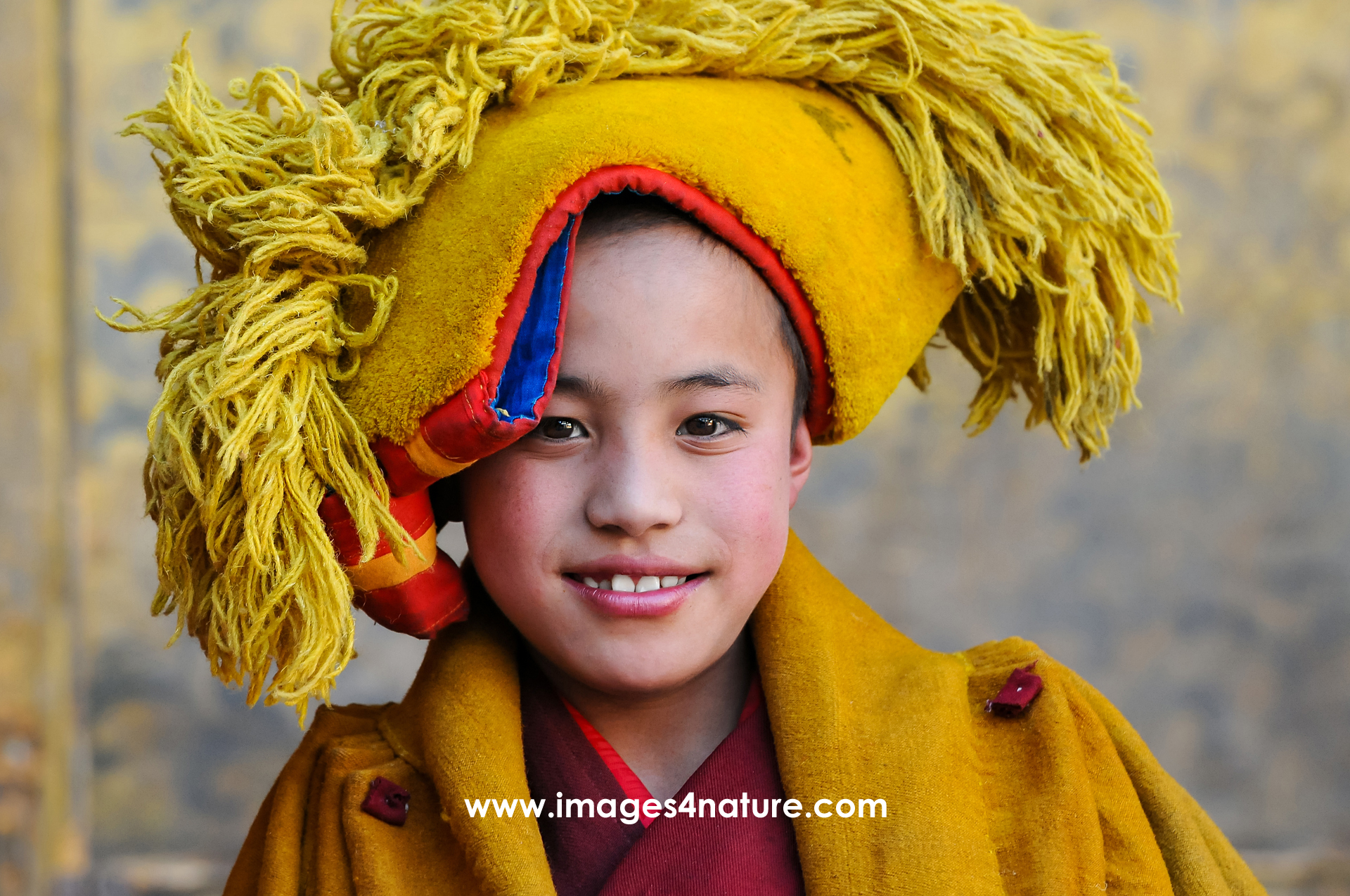 The friendly smile of a young Tibetan novice monk at Tashi Lhunpo monastery