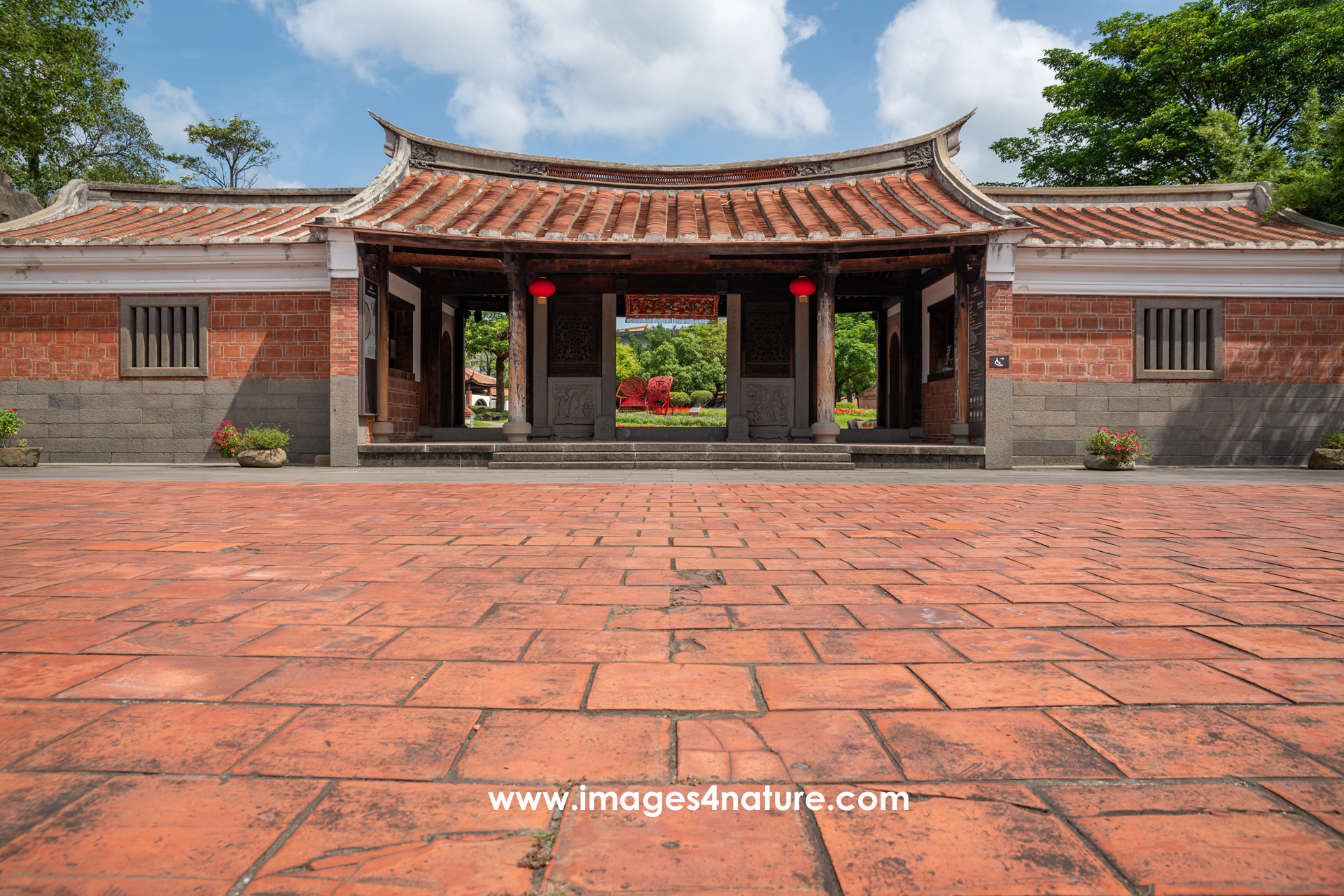 Low-angle view of the entrance of the traditional Chinese architecture Lin An Tai Historic House and Museum, with red tiles making up half of the image