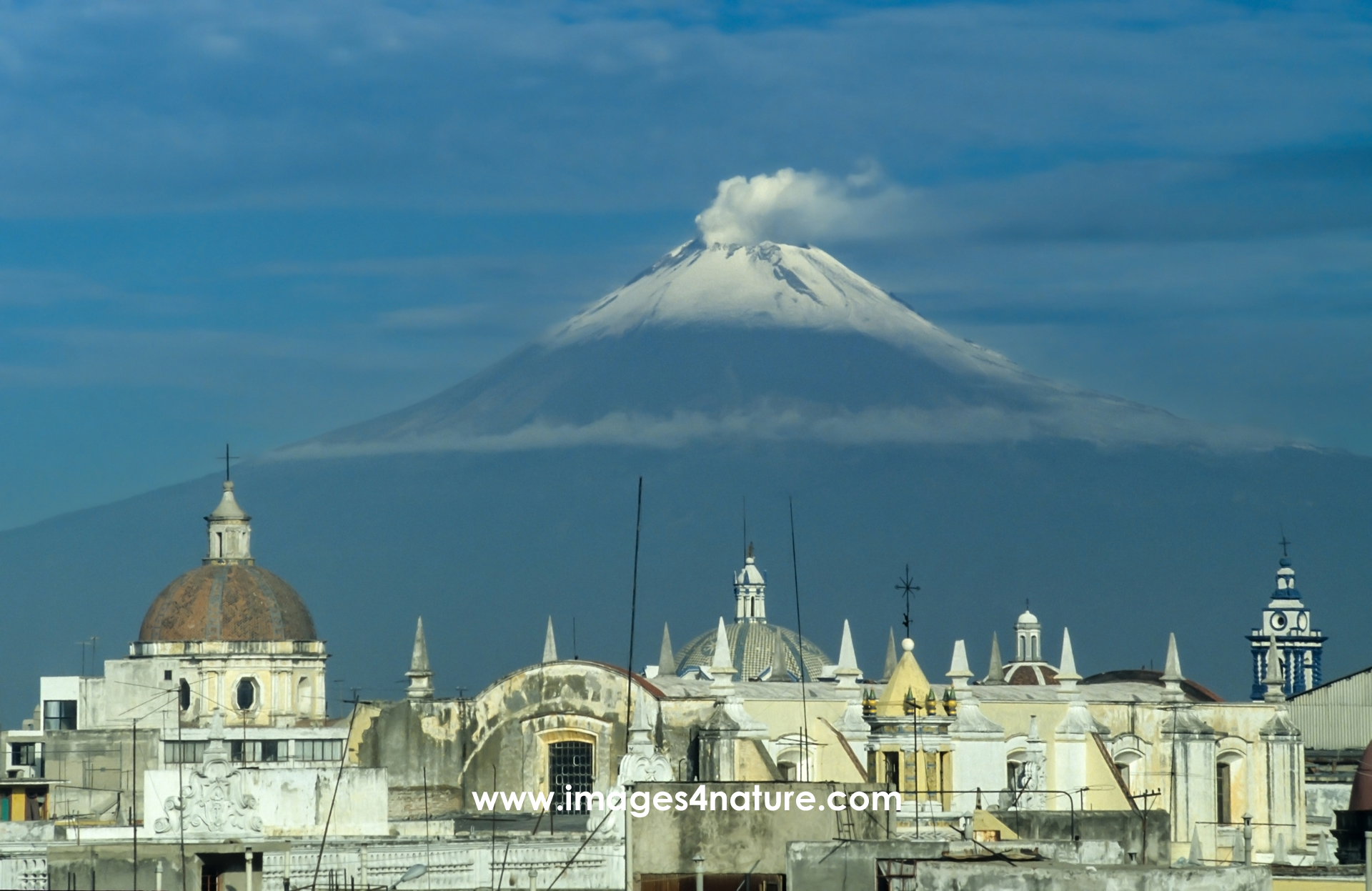 Scenic view of the Puebla skyline with snow-covered volcano peak in the background