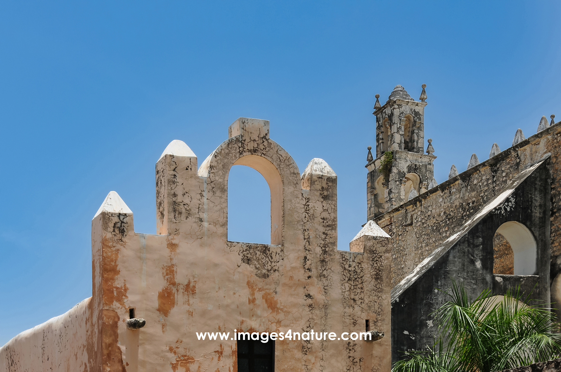 View of a church and attached walls against blue sky