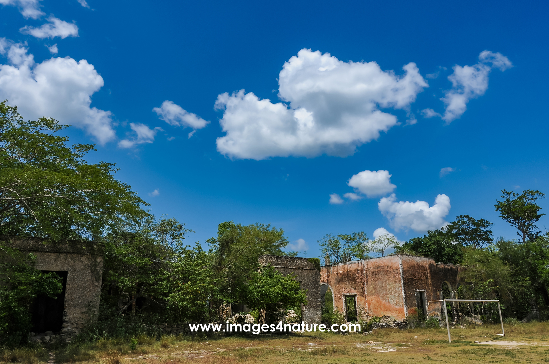 Scenic view of various abandoned houses of an old factory behind a soccer goal