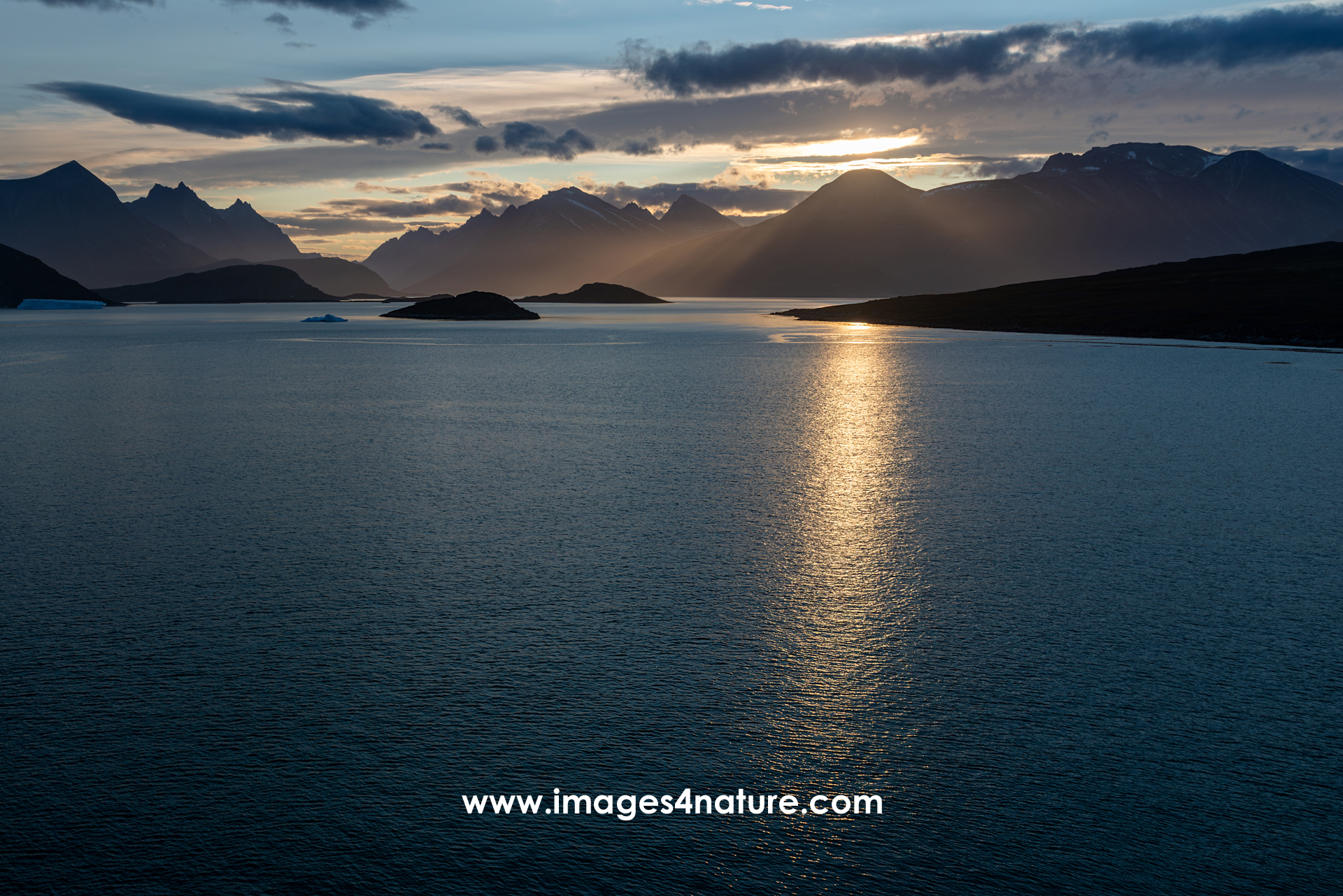 Evening panorama of the mountains surrounding a fjord in south Greenland at sunset